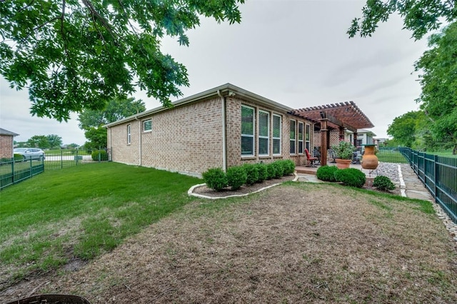 rear view of property featuring a lawn, brick siding, a patio, a fenced backyard, and a pergola