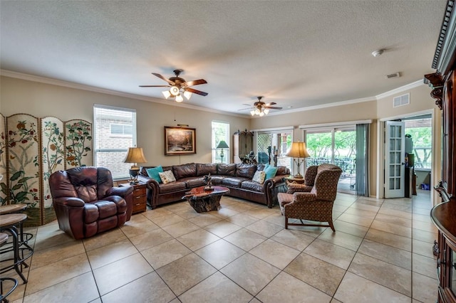living room featuring visible vents, plenty of natural light, crown molding, and ceiling fan