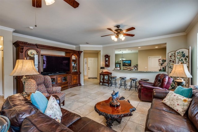 living area with ornamental molding, ceiling fan with notable chandelier, and light tile patterned flooring