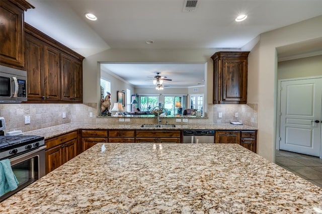 kitchen featuring stainless steel appliances, visible vents, a healthy amount of sunlight, and a sink