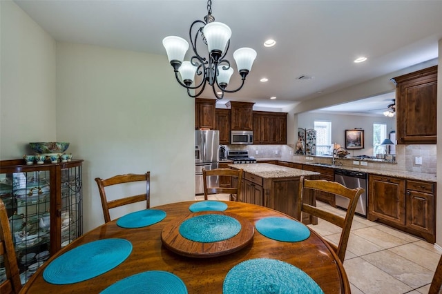 dining area featuring light tile patterned floors, recessed lighting, and a notable chandelier