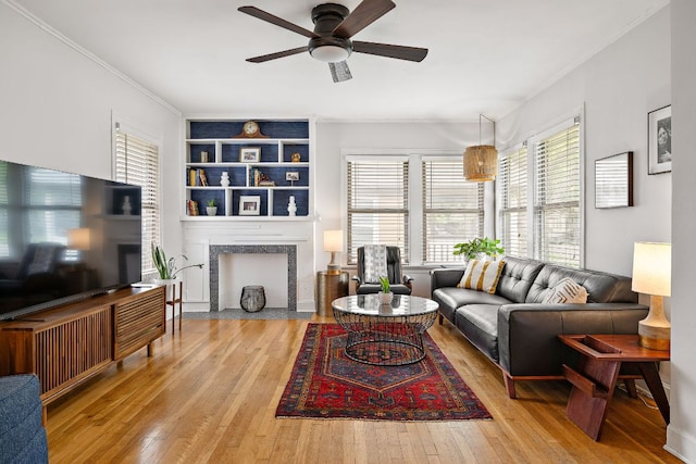 5011 Eilers Ave, Austin, TX 78751 - living area featuring a high end fireplace, hardwood / wood-style flooring, plenty of natural light, and ornamental molding