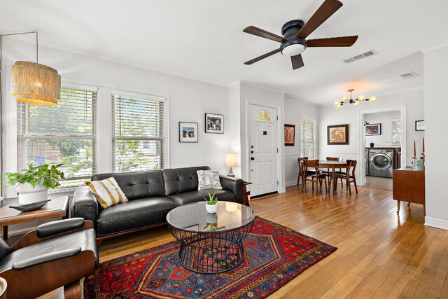 5011 Eilers Ave, Austin, TX 78751 - living area featuring washer / clothes dryer, a chandelier, a ceiling fan, light wood finished floors, and crown molding
