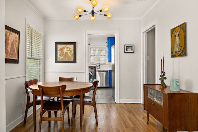 5011 Eilers Ave, Austin, TX 78751 - dining room with plenty of natural light, ornamental molding, baseboards, and wood finished floors