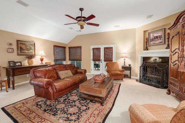 living area with vaulted ceiling, ceiling fan, light colored carpet, and visible vents