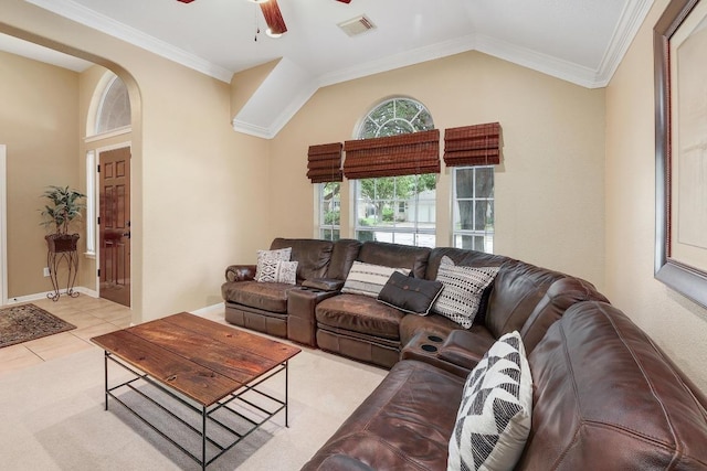 living area featuring a ceiling fan, visible vents, light tile patterned floors, baseboards, and lofted ceiling