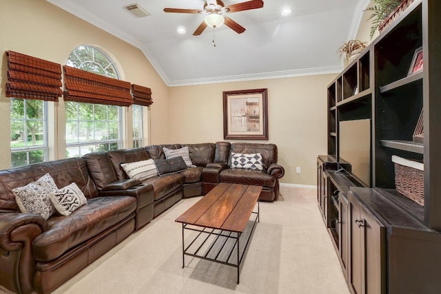 living area with crown molding, light colored carpet, a ceiling fan, a wealth of natural light, and visible vents