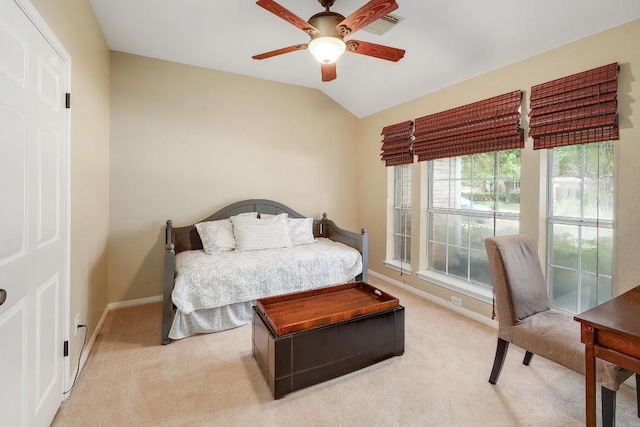 bedroom with ceiling fan, light colored carpet, baseboards, lofted ceiling, and visible vents