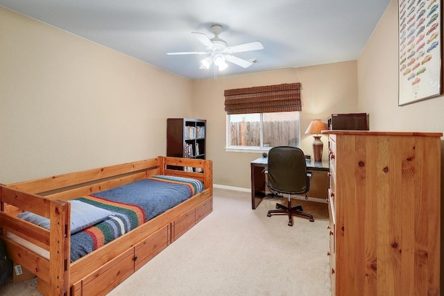carpeted bedroom featuring baseboards and a ceiling fan