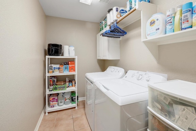 laundry room featuring visible vents, light tile patterned flooring, baseboards, cabinet space, and independent washer and dryer