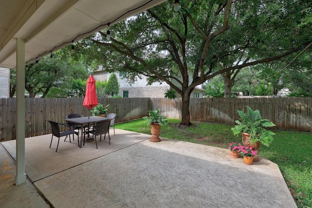 view of patio featuring a fenced backyard and outdoor dining space