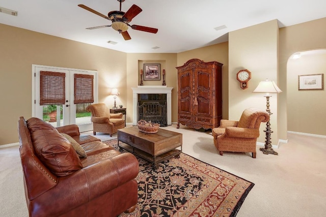 living room with french doors, carpet floors, baseboards, and a ceiling fan