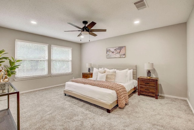 carpeted bedroom featuring baseboards, ceiling fan, recessed lighting, and visible vents