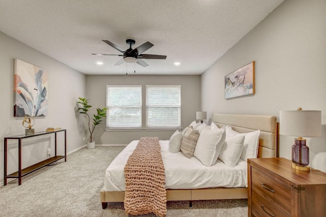 bedroom featuring baseboards, carpet, a ceiling fan, and a textured ceiling