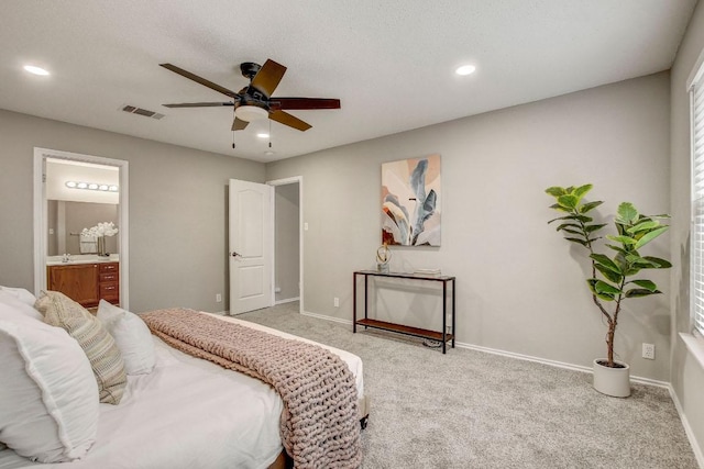 carpeted bedroom featuring visible vents, recessed lighting, baseboards, and ensuite bathroom