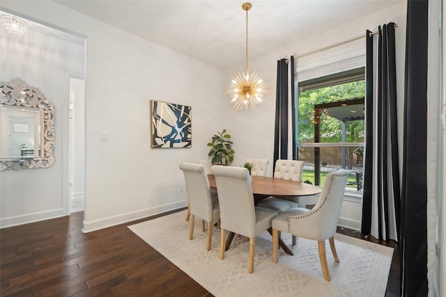 dining space with baseboards, a notable chandelier, and dark wood-style floors
