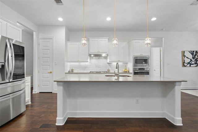 kitchen with a sink, white cabinets, backsplash, and stainless steel appliances