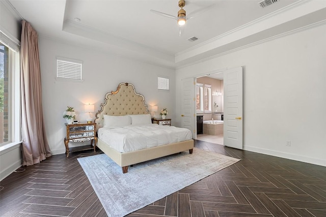 bedroom featuring crown molding, baseboards, a tray ceiling, and visible vents