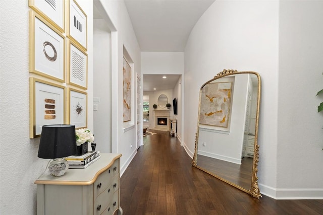 hallway with baseboards and dark wood-style floors