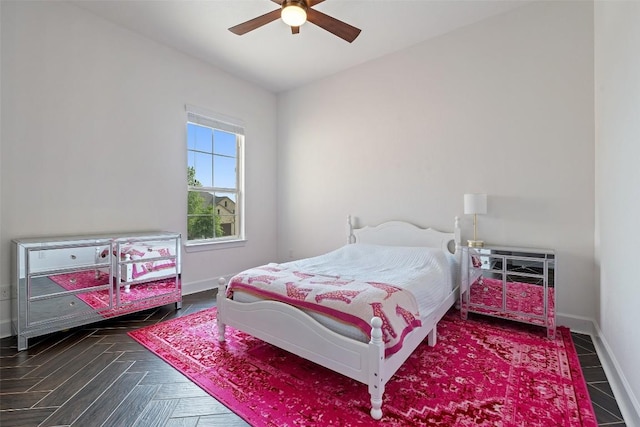 bedroom featuring baseboards and ceiling fan