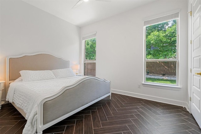 bedroom featuring baseboards and ceiling fan