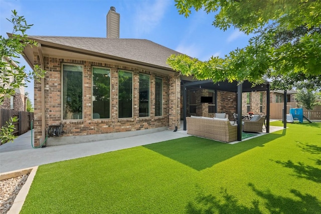 back of property with an outdoor hangout area, fence, a patio, and brick siding