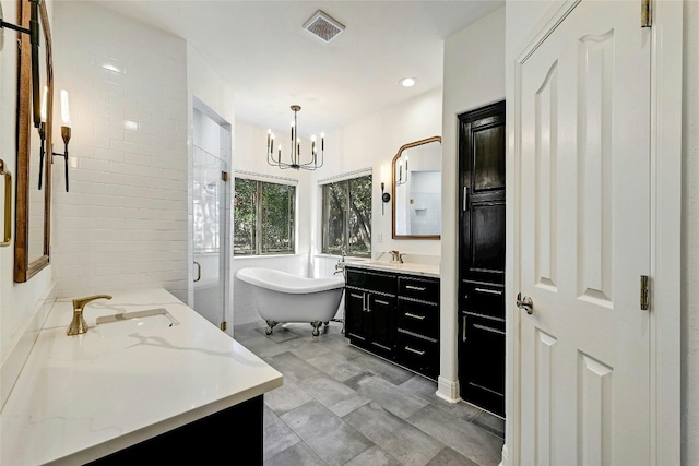 201 Explorer, Lakeway, TX 78734 - full bathroom with two vanities, a chandelier, a freestanding tub, a shower stall, and recessed lighting
