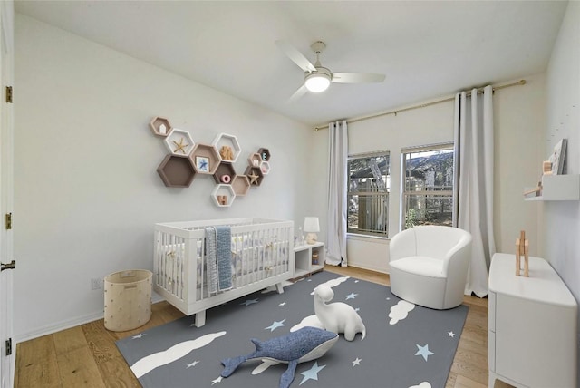201 Explorer, Lakeway, TX 78734 - bedroom featuring wood finished floors, a nursery area, and a ceiling fan