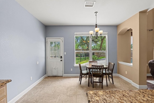 dining space with arched walkways, light tile patterned flooring, visible vents, and an inviting chandelier