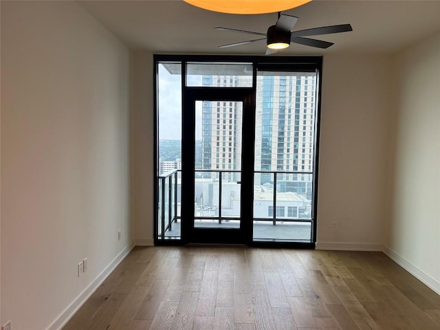 84 E Ave Unit 2207, Austin, TX 78701 - unfurnished room with plenty of natural light, floor to ceiling windows, and wood finished floors