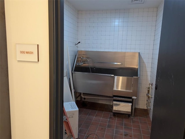 84 E Ave Unit 2207, Austin, TX 78701 - miscellaneous room with dark tile patterned floors and tile walls