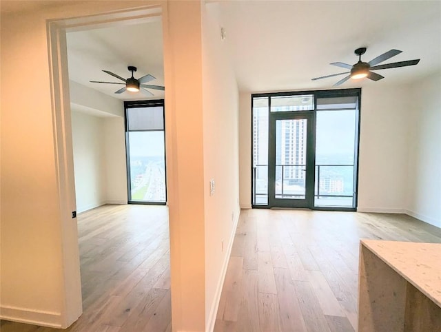 84 E Ave Unit 2207, Austin, TX 78701 - interior space featuring light wood-style floors, baseboards, and ceiling fan