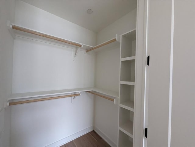 84 E Ave Unit 2207, Austin, TX 78701 - walk in closet with dark wood-style flooring