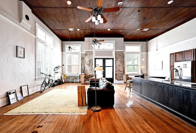 living area with ceiling fan, wood ceiling, and light wood-style floors