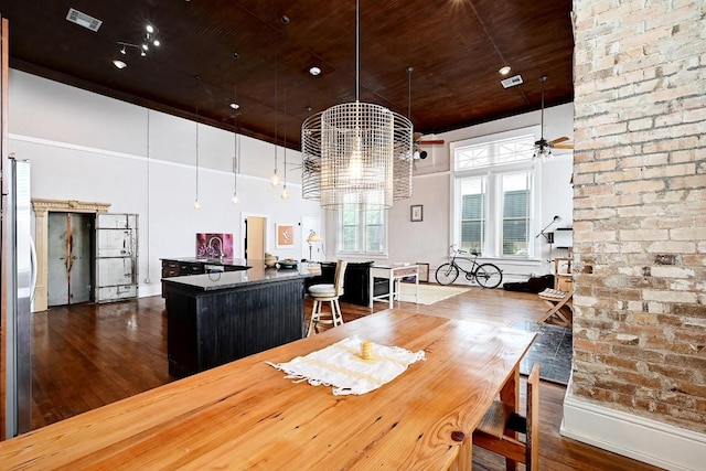 dining room featuring visible vents, dark wood-style flooring, a high ceiling, wooden ceiling, and ceiling fan with notable chandelier