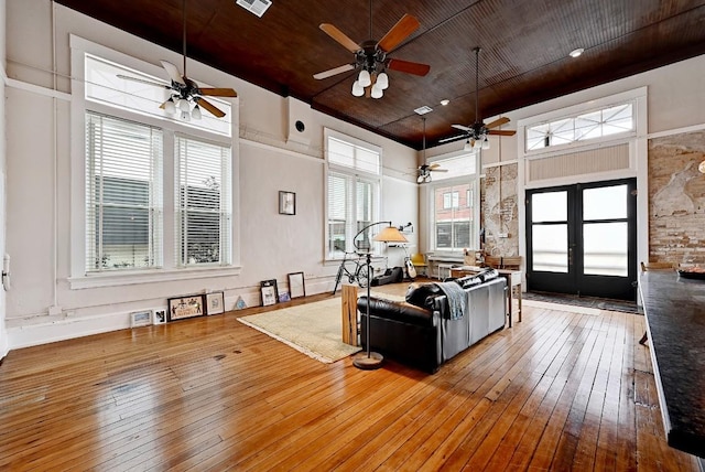 living room with visible vents, wood-type flooring, wood ceiling, french doors, and a ceiling fan