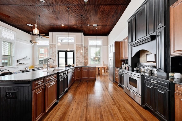 kitchen with a sink, appliances with stainless steel finishes, wooden ceiling, and ceiling fan