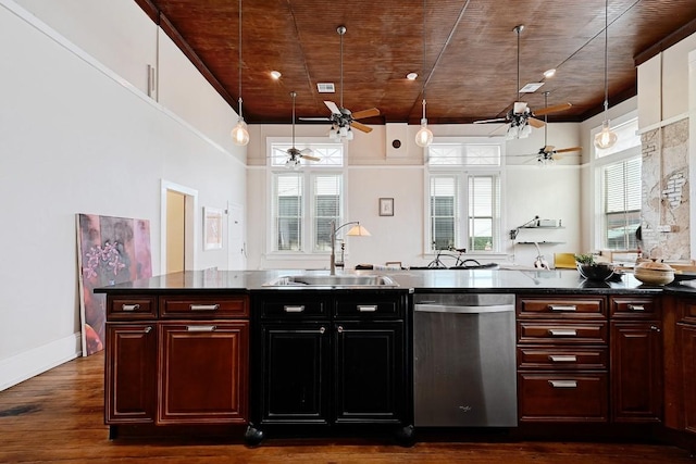 kitchen featuring dark countertops, ceiling fan, dark wood-type flooring, a sink, and dishwasher