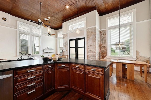 kitchen with dark wood-style flooring, a healthy amount of sunlight, and wooden ceiling