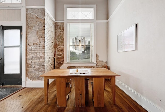 dining room featuring baseboards and wood finished floors