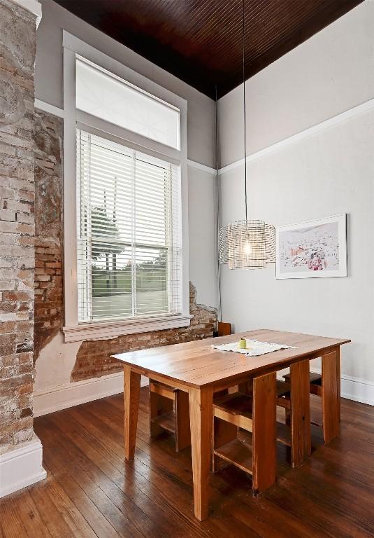 dining room with baseboards and hardwood / wood-style floors