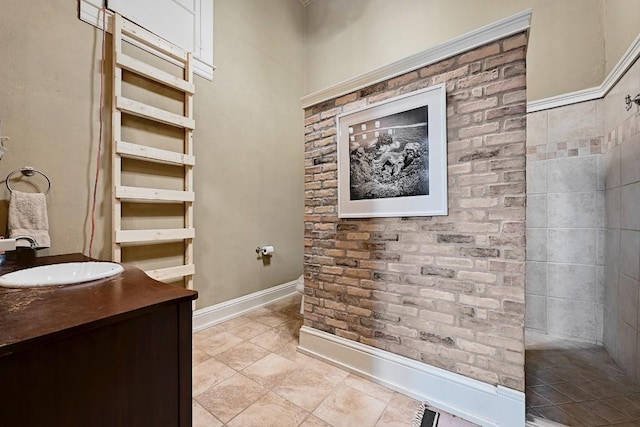 full bath with baseboards, tile patterned floors, and vanity