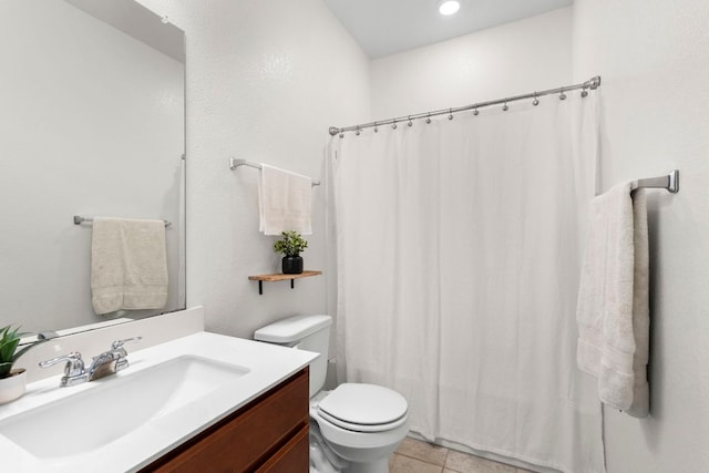 bathroom with vanity, a shower with shower curtain, tile patterned floors, and toilet