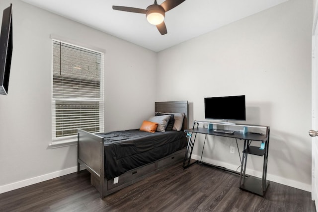 bedroom with a ceiling fan, baseboards, and wood finished floors