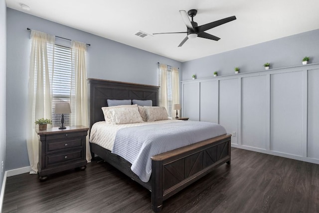 bedroom featuring ceiling fan, dark wood finished floors, and visible vents