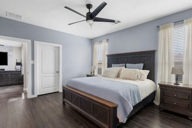bedroom with ceiling fan, dark wood-type flooring, and visible vents