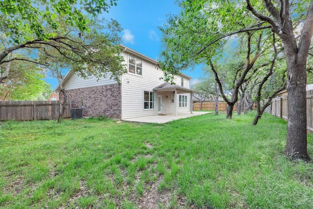 1205 Yountville Dr, Leander, TX 78641 - rear view of property with a patio, a fenced backyard, and brick siding