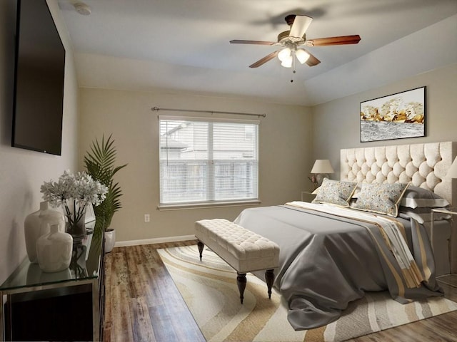 bedroom with baseboards, ceiling fan, and wood finished floors