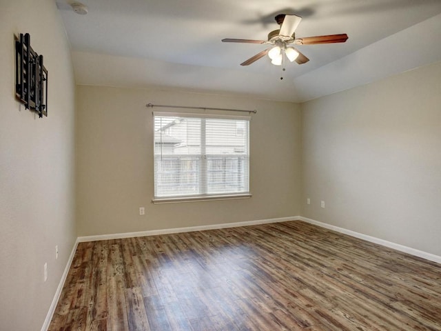 spare room featuring baseboards, ceiling fan, and wood finished floors