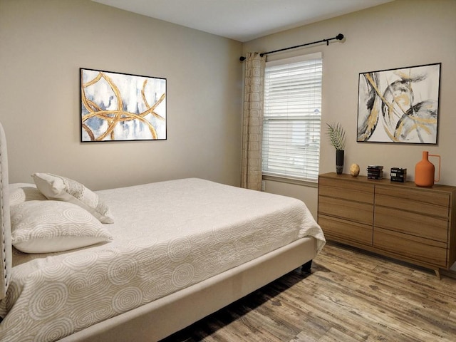 bedroom featuring light wood-style floors